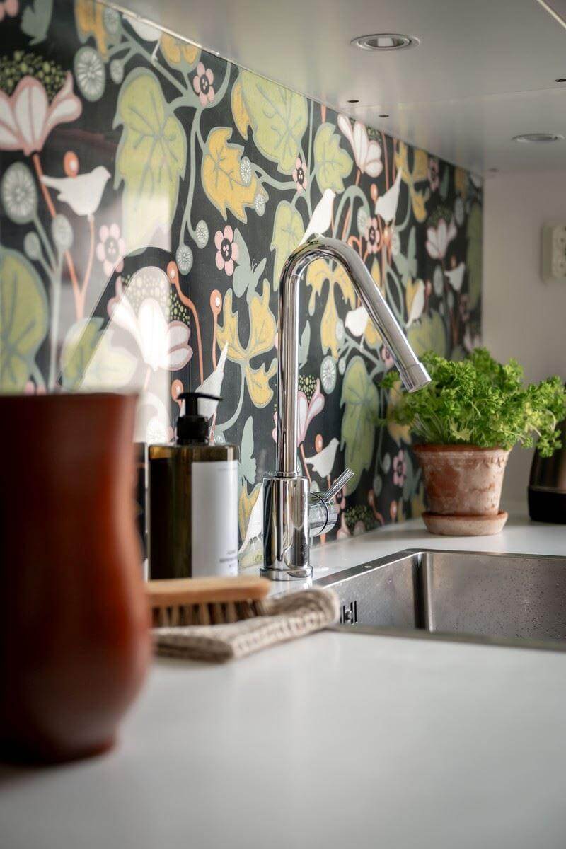 A Bright Swedish Apartment with Subtle Color Accents 11 wallpapered backsplash detail nordroom