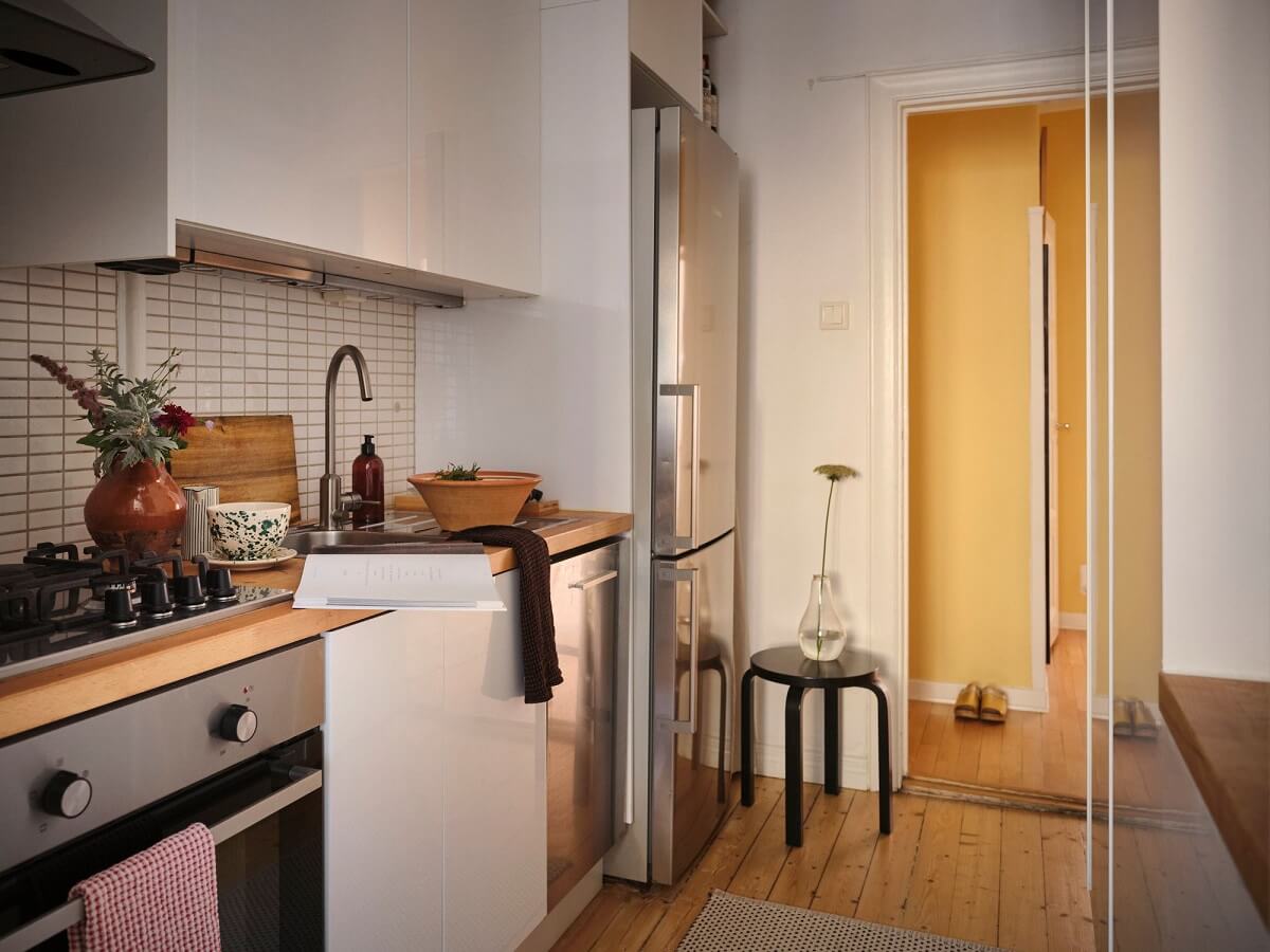 Muted Gray, Green, and Yellow Walls in a Stockholm Apartment 10 white kitchen