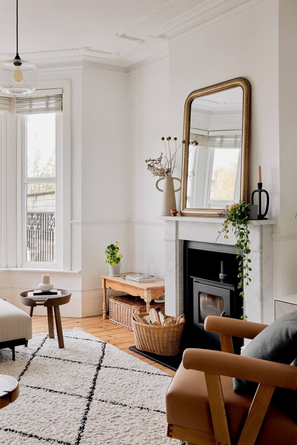 Light and Modern Spaces in an Award-Winning London House 2 white living room with fireplace and rusty red armchair nordroom