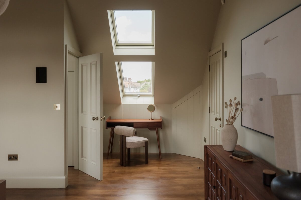 A Calm Color Palette and Warm Materials in a London Home 25 attic bedroom with desk under skylight