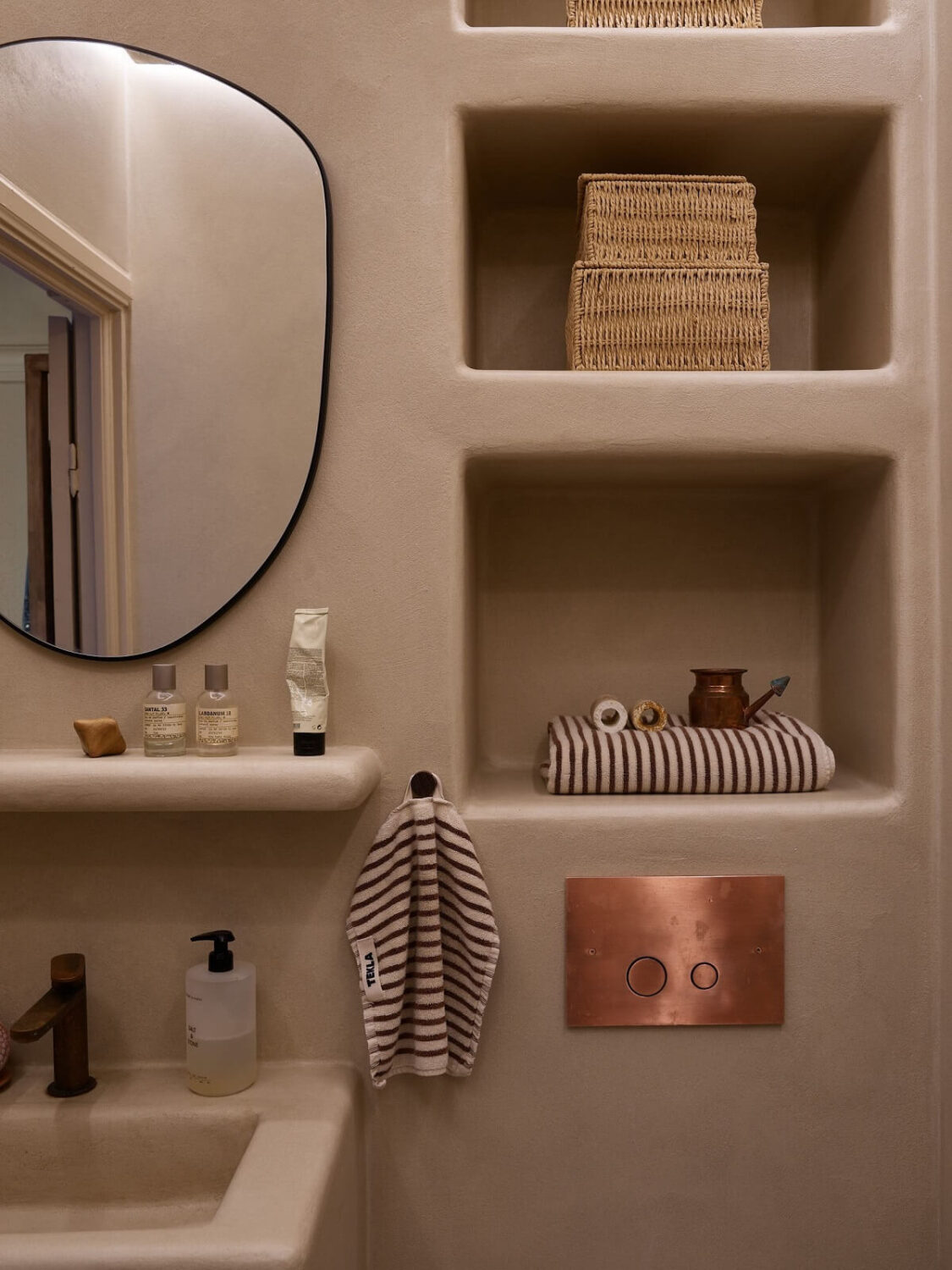 A Studio Apartment with Plaster Walls and a Walnut Kitchen 16 bathroom built in storage shelves