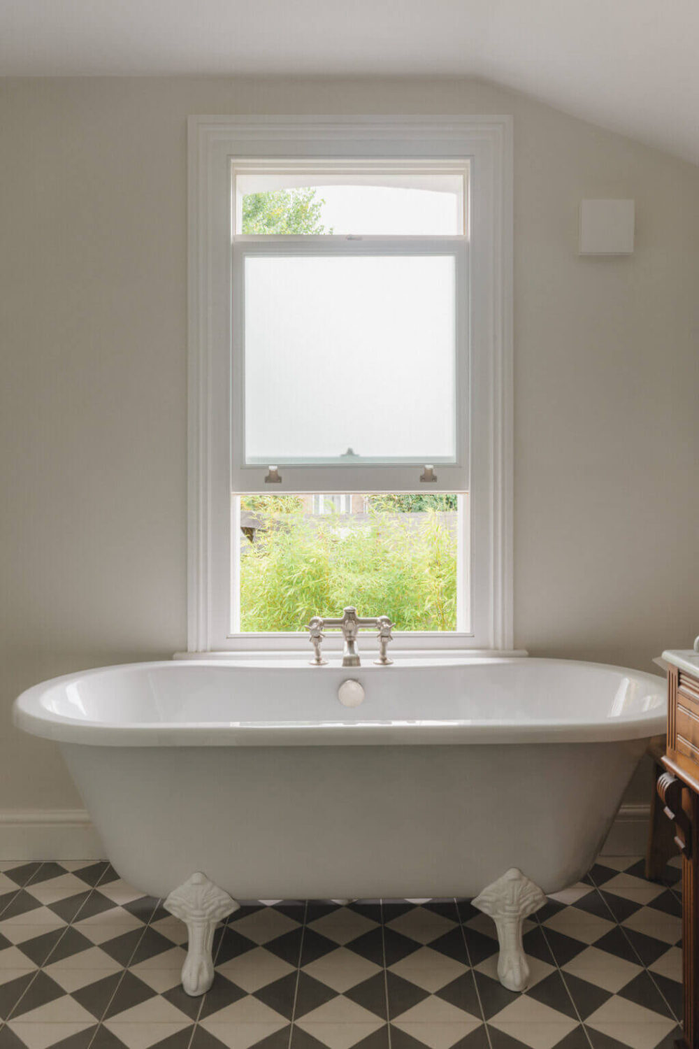 A Soft and Natural Color Palette in a Victorian Home 14 bathroom with bath under window and checkerboard floor