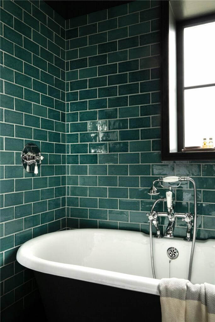 A Stylish Two Bedroom Maisonette in London 14 bathroom with dark green tiles and black ceiling