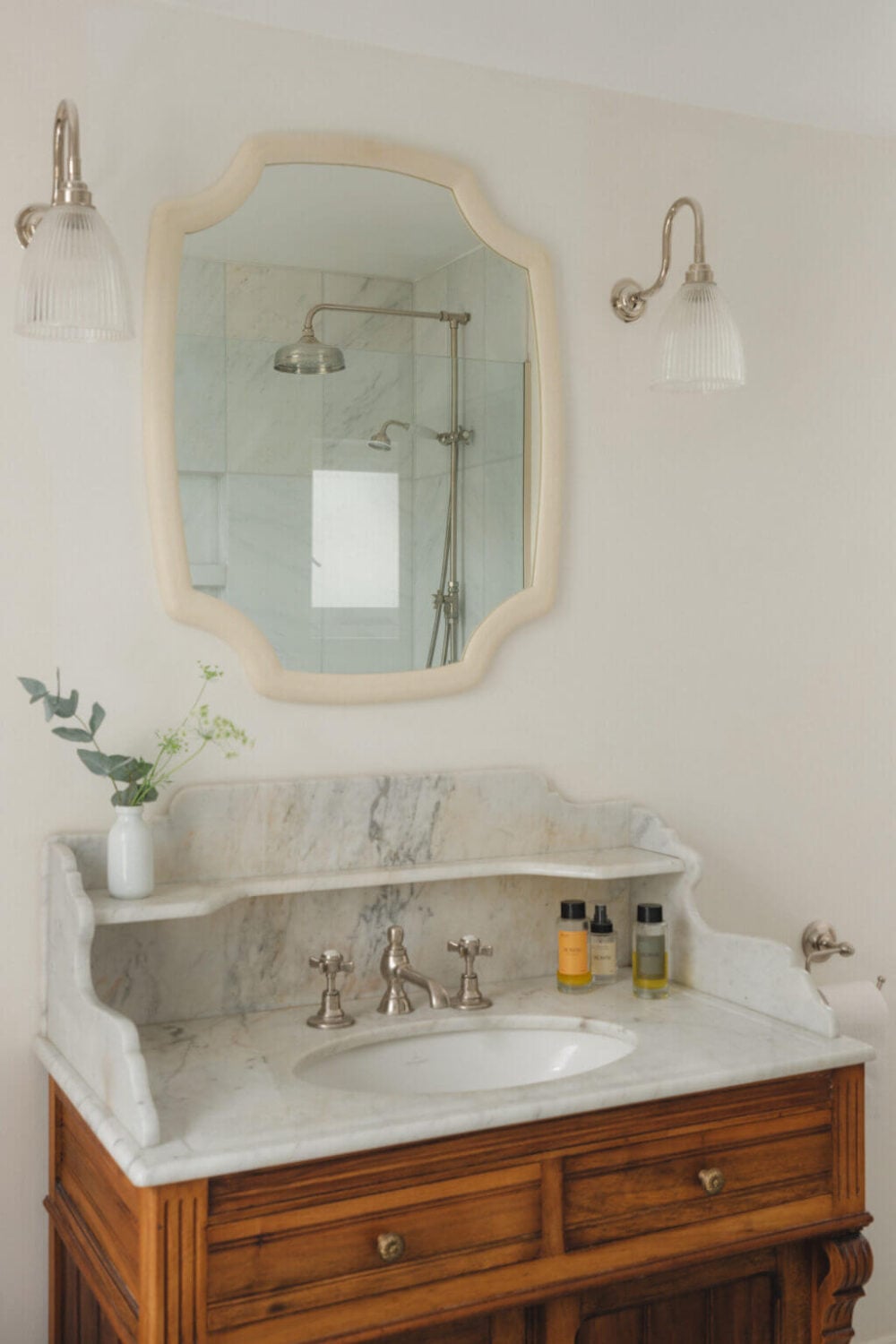 A Soft and Natural Color Palette in a Victorian Home 15 bathroom with wooden vanity topped with marble
