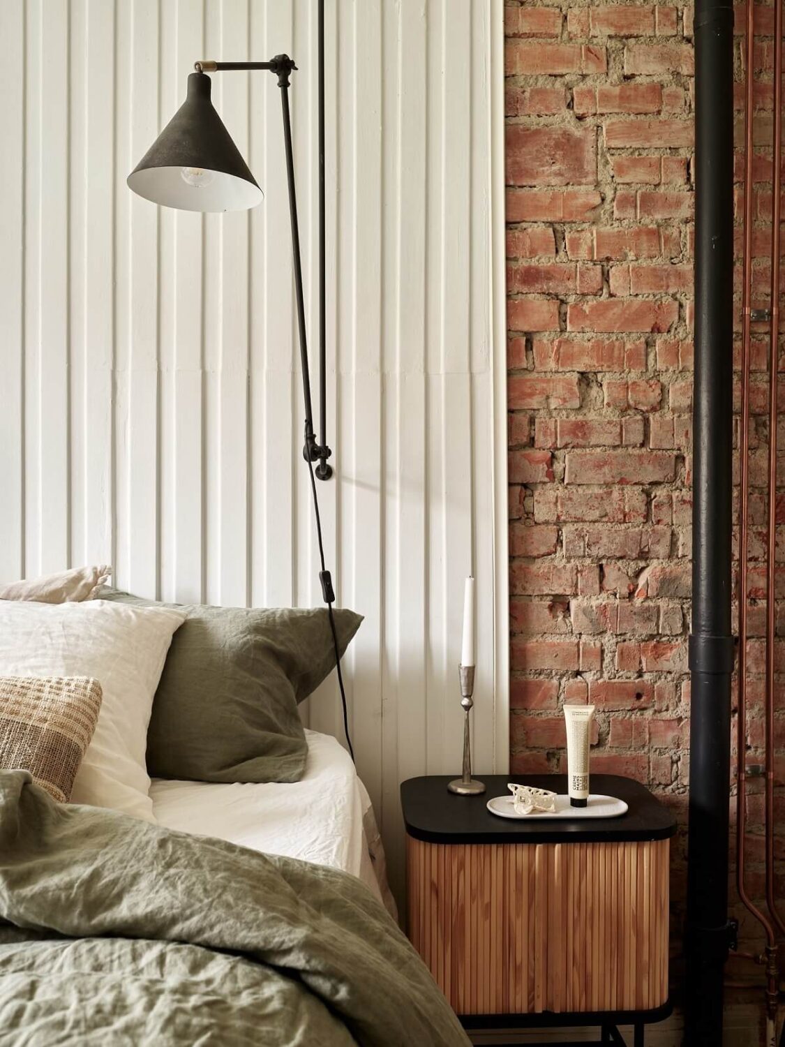 A Swedish Apartment with a Dark Blue Living Room and Exposed Brick 12 bedroom detail with wood and brick wall