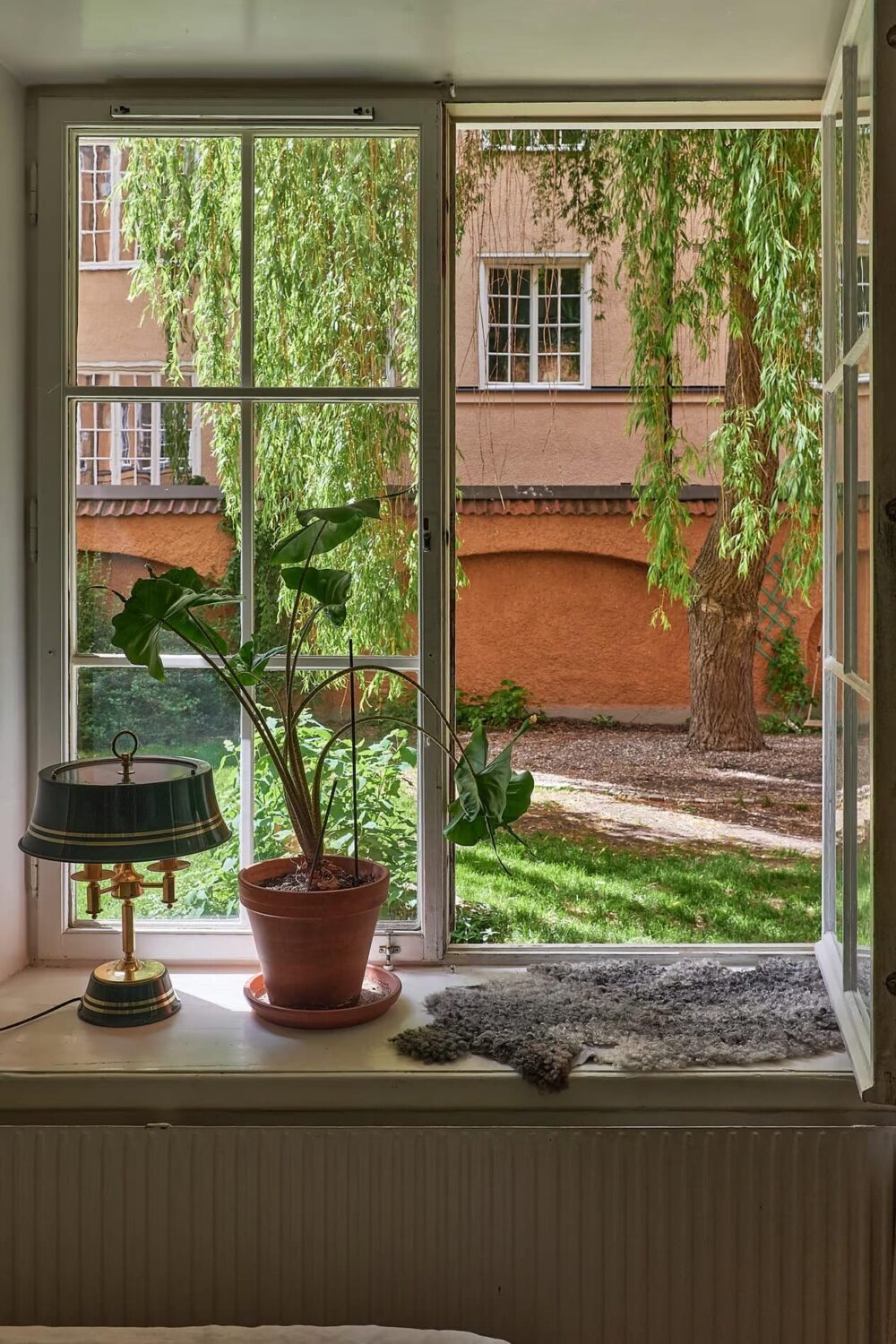 Soothing Colors and Smart Solutions in a Two Bedroom Apartment 13 bedroom window with courtyard view