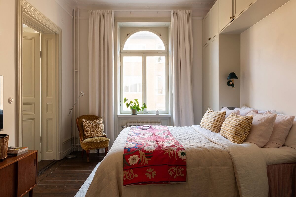A Beautiful Turn-of-the-Century Apartment with Bold Color Accents 23 bedroom with arched window