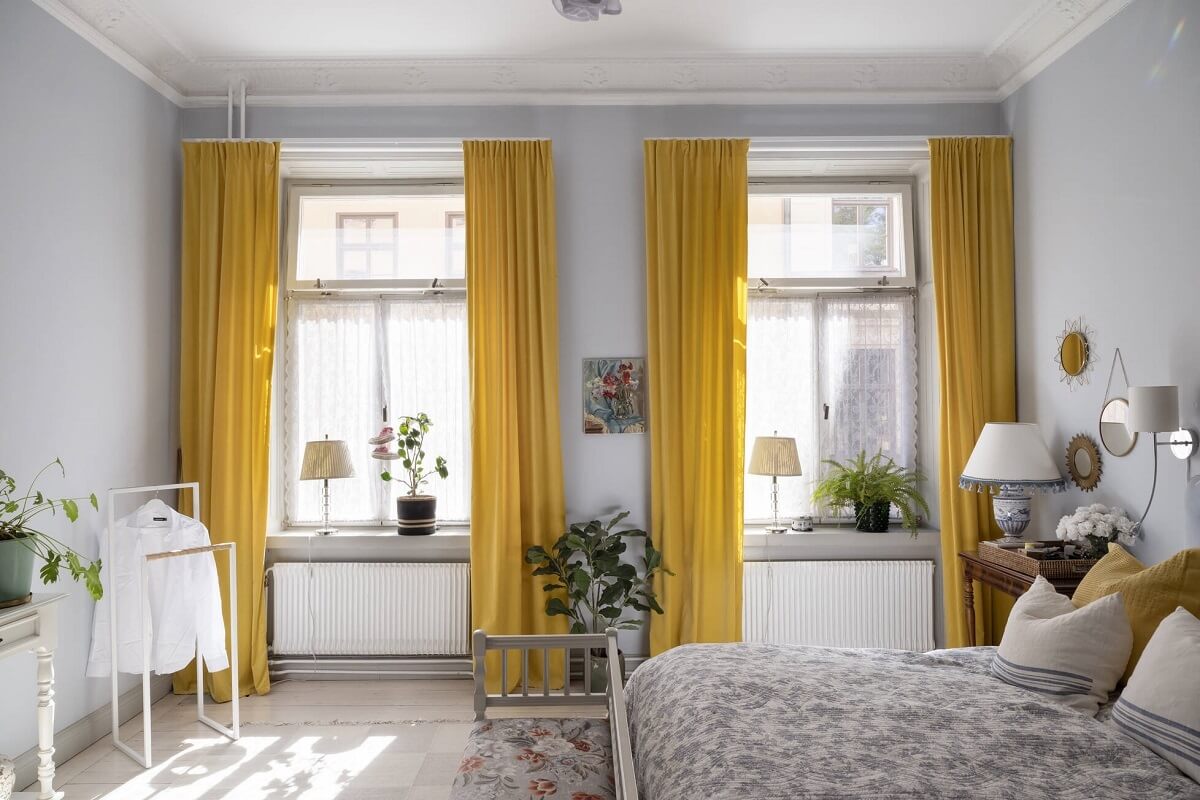 Bright, Spacious Rooms in a Classic Stockholm Apartment 14 bedroom with bright yellow curtains