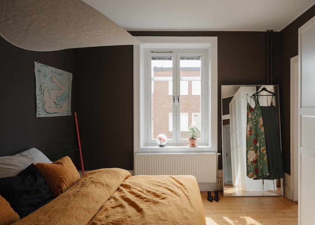 An Apartment with William Morris Wallpaper and a Dull Plum Bedroom 16 bedroom with deep plum wall color and ochre bedding nordroom
