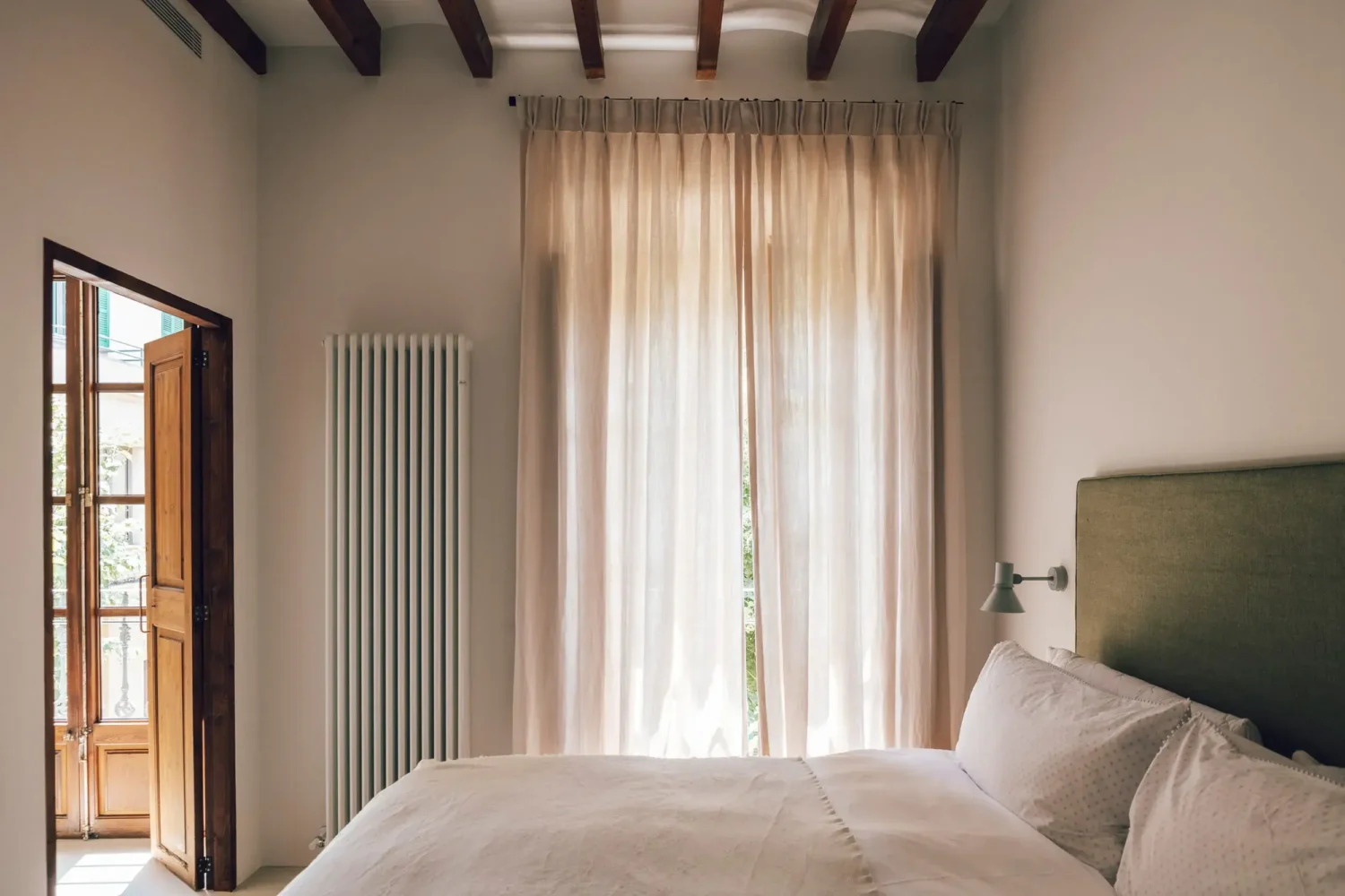 Beautiful Period Features in an Early 20th-Century Majorcan Townhouse 8 bedroom with green headboard and wooden beams