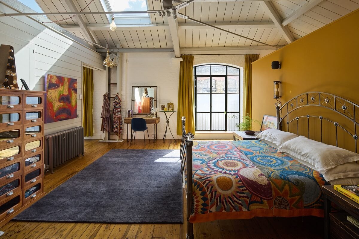 An Industrial and Colorful Warehouse Conversion in London 12 bedroom with wooden ceiling and ochre yellow wall