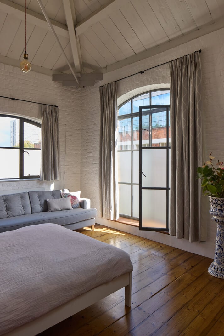 An Industrial and Colorful Warehouse Conversion in London 18 bedroom wooden floorboards