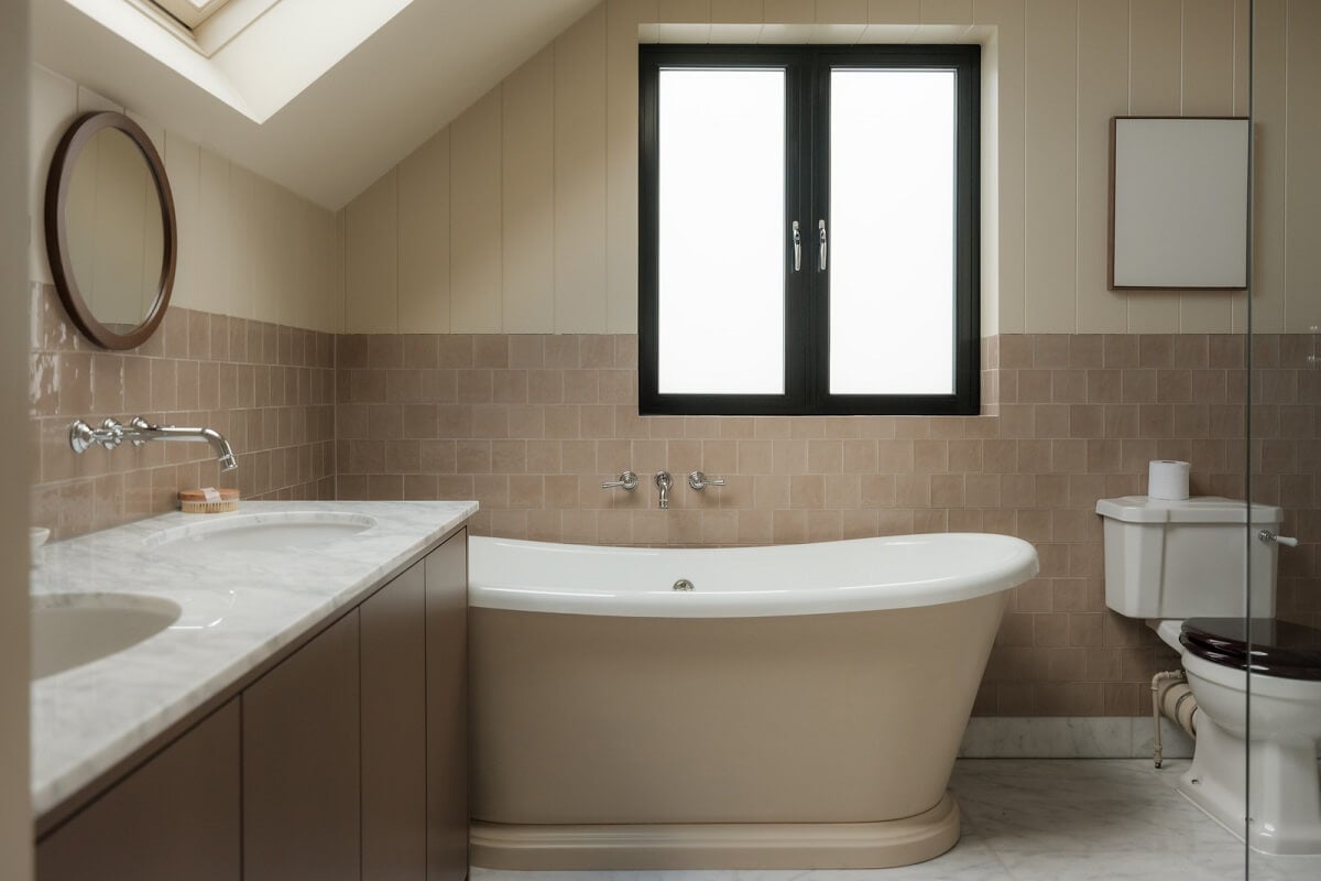 A Calm Color Palette and Warm Materials in a London Home 26 beige bathroom with freestanding bath