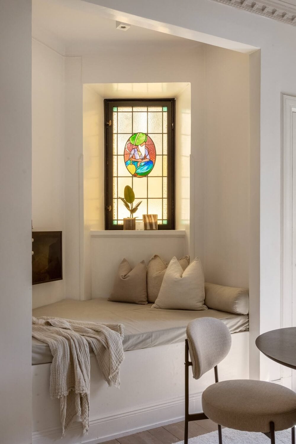 A Tiny Minimalistic Apartment in Stockholm 5 built in sofa with stained glass window nordroom