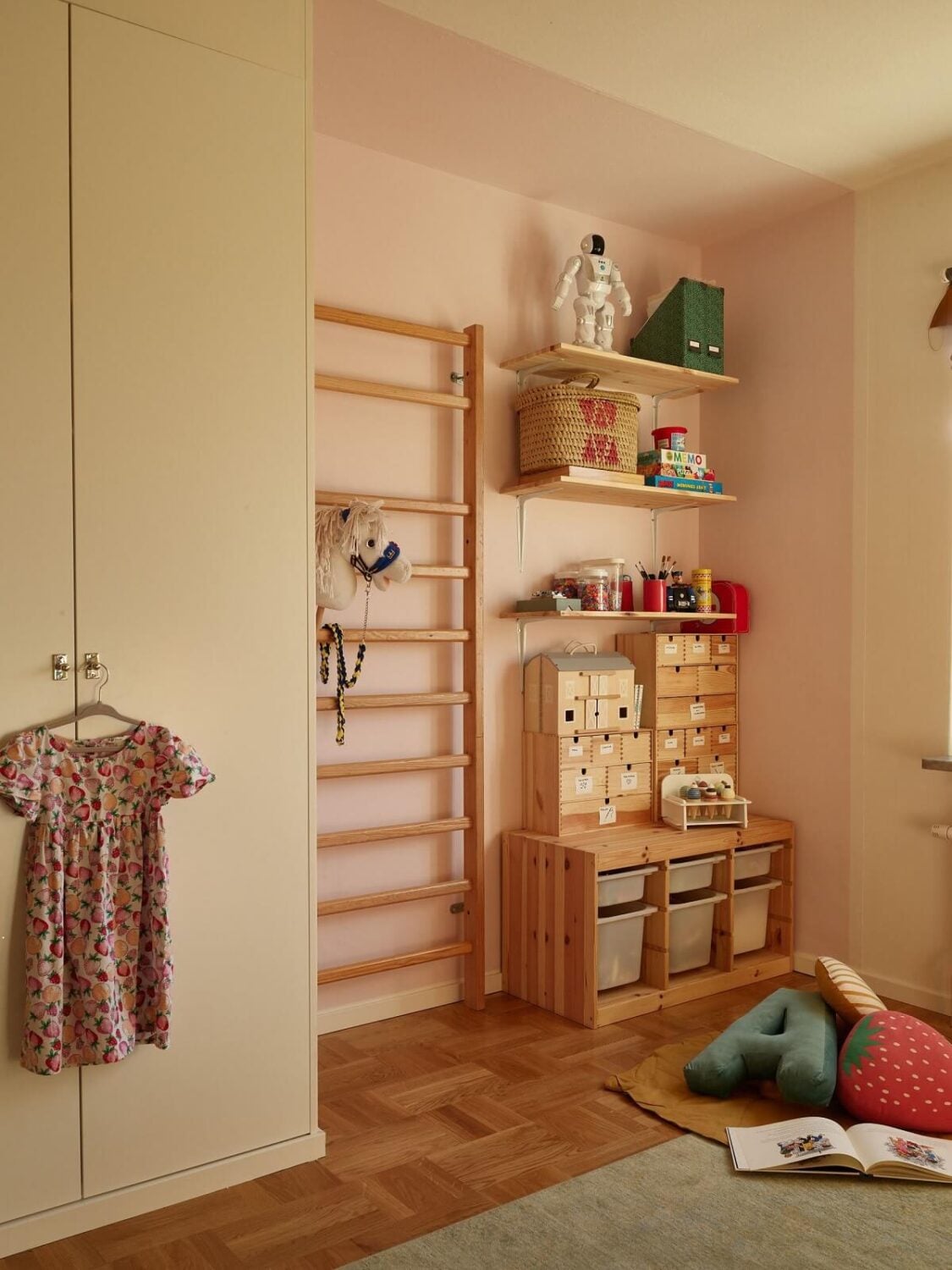 A Midcentury Swedish Apartment with Bold Colors 19 childrens bedroom with light pink accent wall