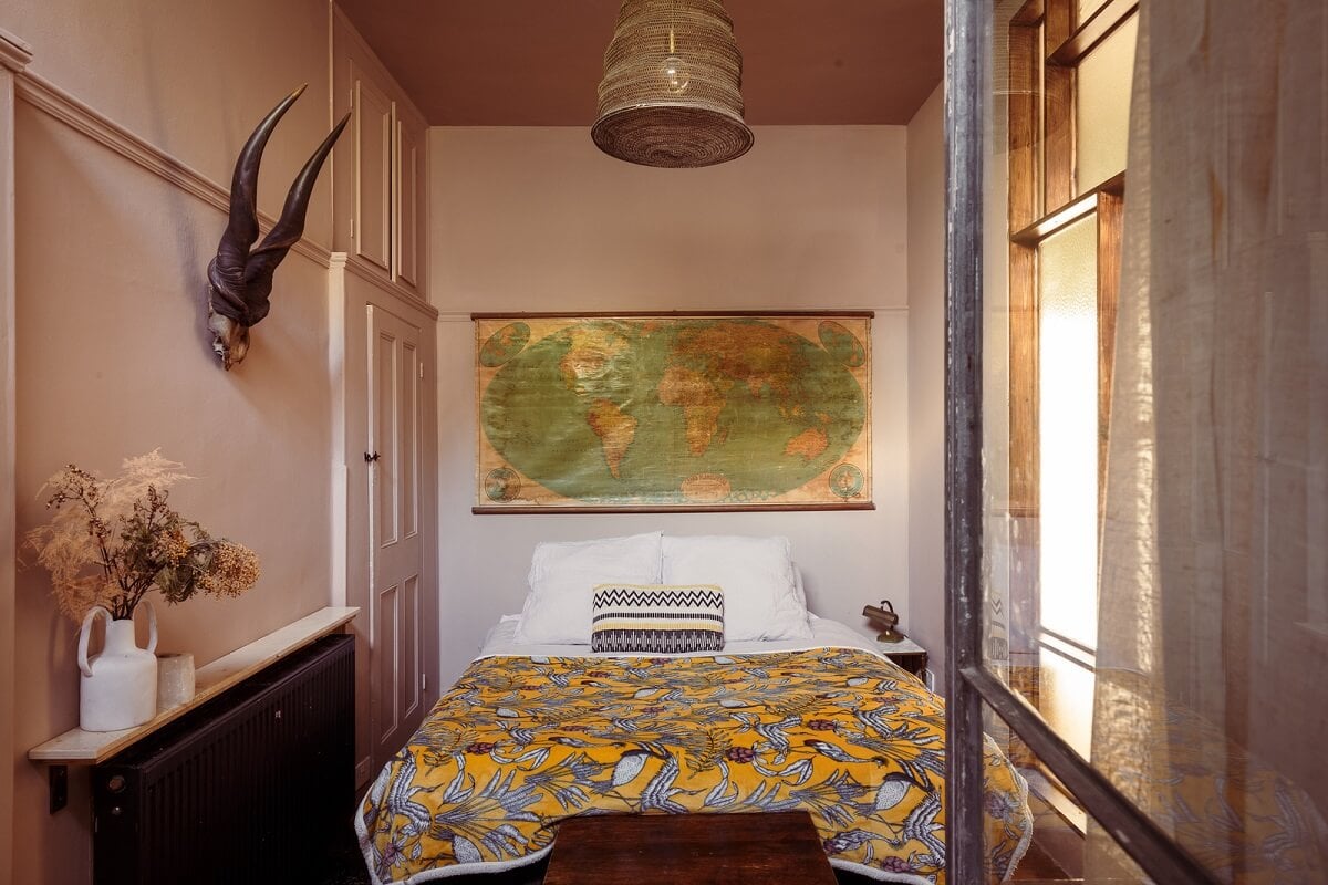 A Warm Ground Floor Apartment with Reclaimed Materials 14 cozy narrow bedroom with painted ceiling