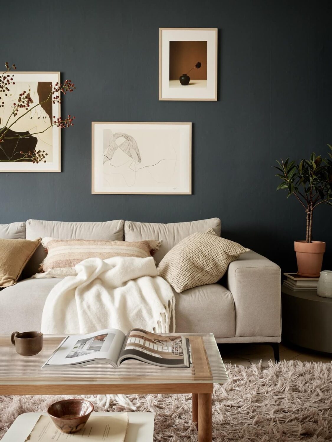 A Swedish Apartment with a Dark Blue Living Room and Exposed Brick 4 dark scandinavian living room
