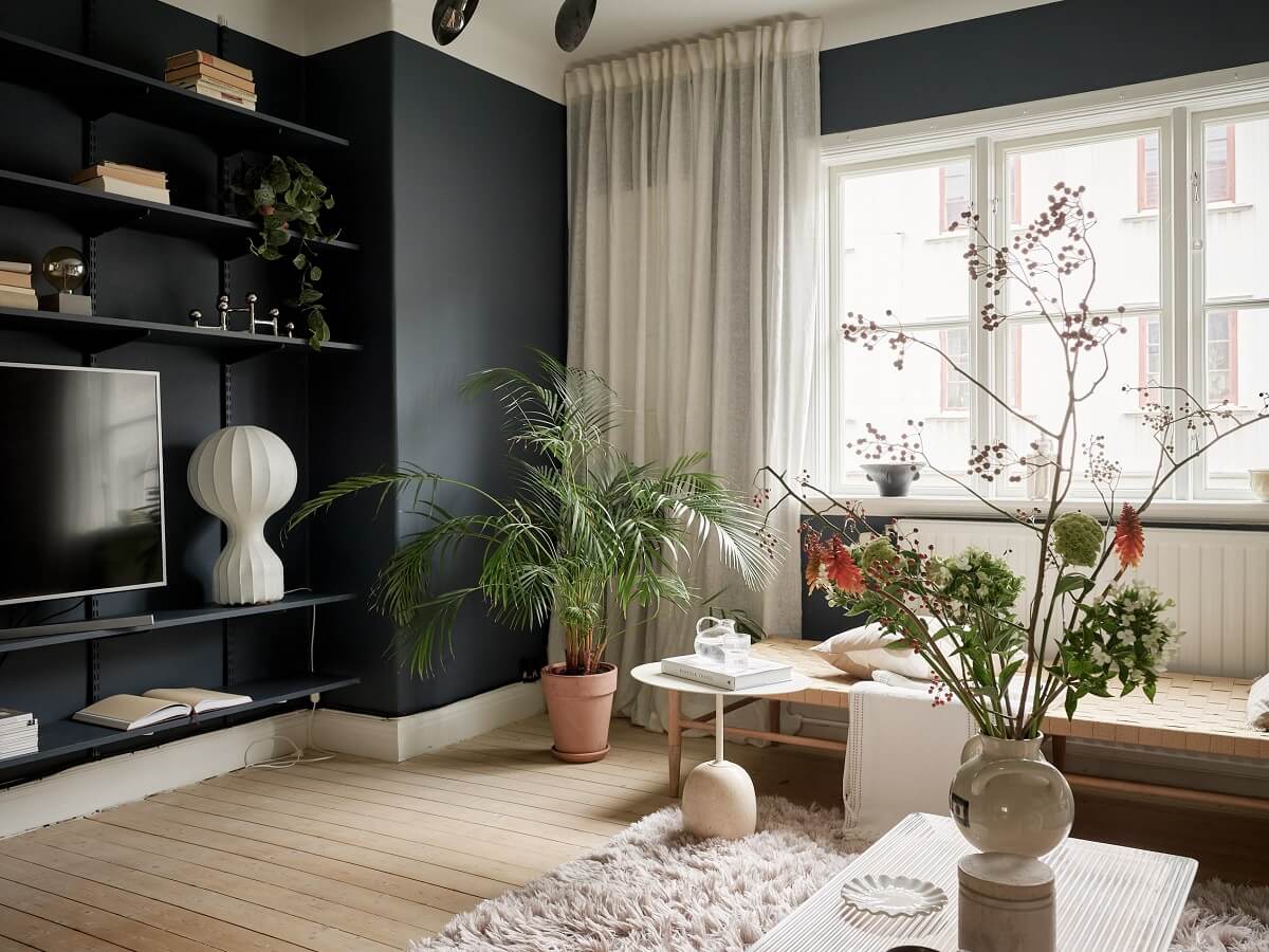 A Swedish Apartment with a Dark Blue Living Room and Exposed Brick 5 dark walls living room with shelves