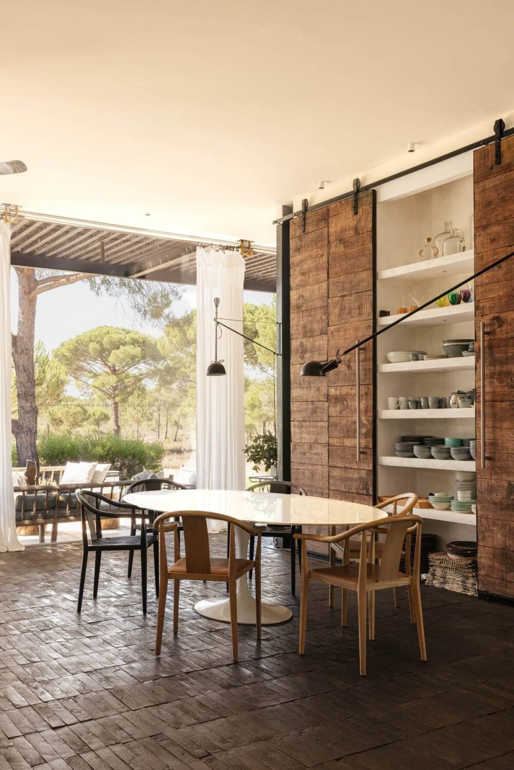An Eco-Retreat Made from Upcycled Materials in Portugal 3 dining room with built in shelves and barn doors An Eco-Retreat Made from Upcycled Materials in Portugal