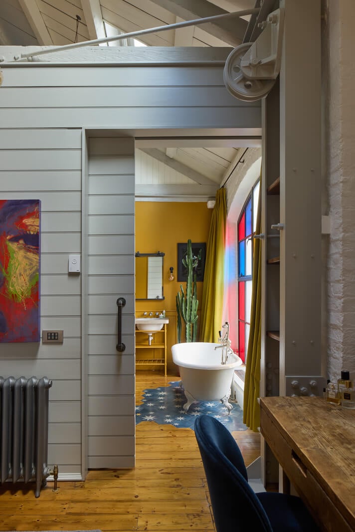 An Industrial and Colorful Warehouse Conversion in London 14 en suite bathroom yellow wall