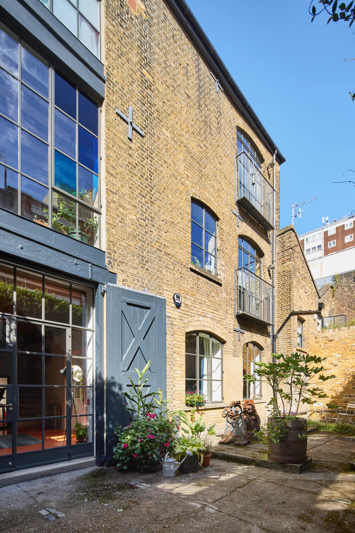 An Industrial and Colorful Warehouse Conversion in London 24 exterior warehouse conversion london