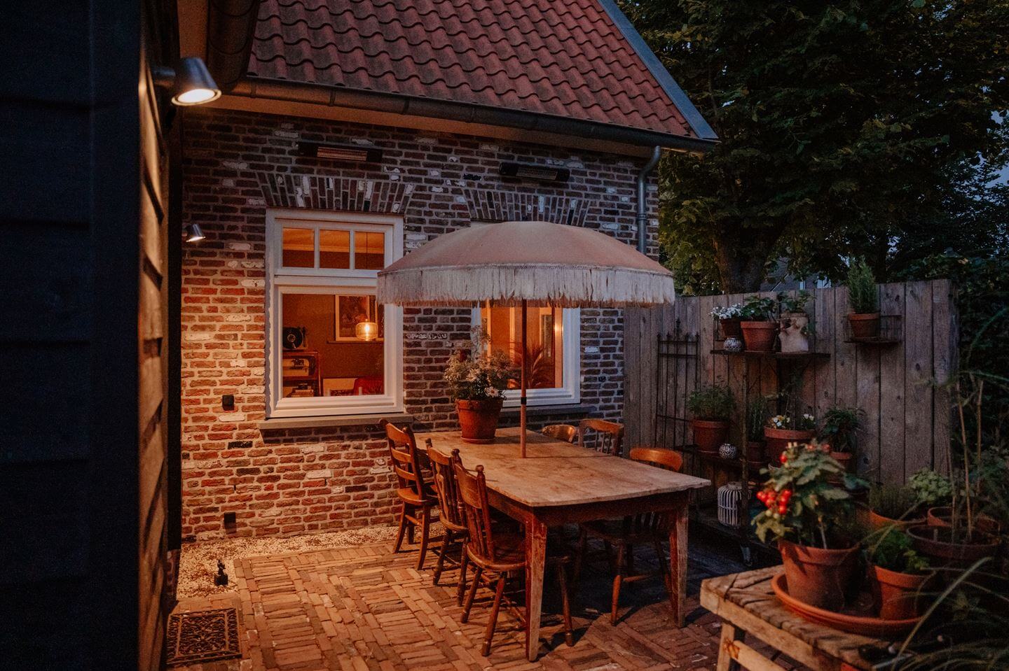 Historic Charm in a New Country House in The Netherlands 28 garden dining space evening