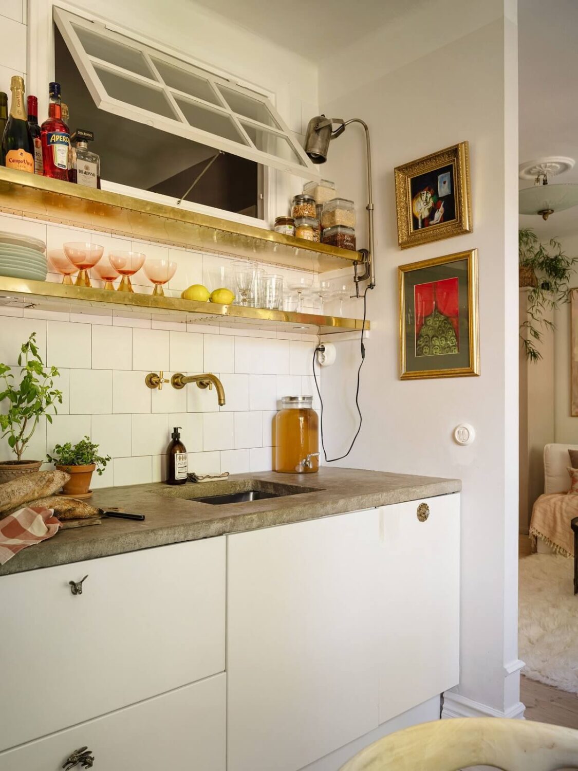 A Light and Well-Planned Apartment in Stockholm 14 golden shelves white kitchen nordroom