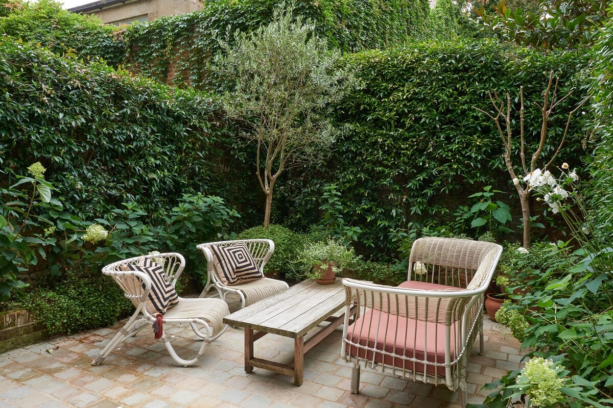 A Luxurious Two-Bedroom Maisonette in Primrose Hill 21 green garden with rattan seaing