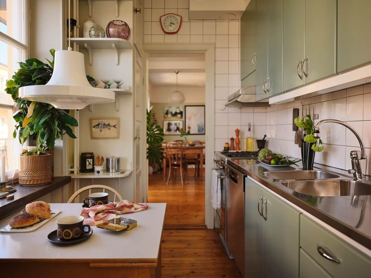 A Charming Small Two-Bedroom Apartment in Stockholm 11 green kitchen with small table