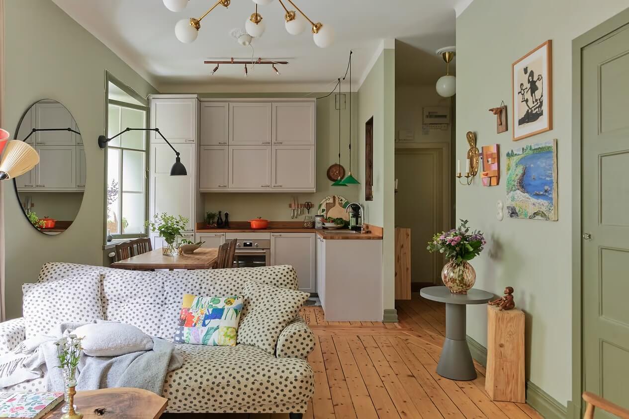 Soothing Colors and Smart Solutions in a Two Bedroom Apartment 1 green living room with oped kitchen and dotted sofa nordroom