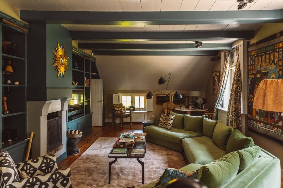 An Eclectic Colorful House in an Old Dutch Farmhouse 3 green living room with wooden beams and large velvet sofa
