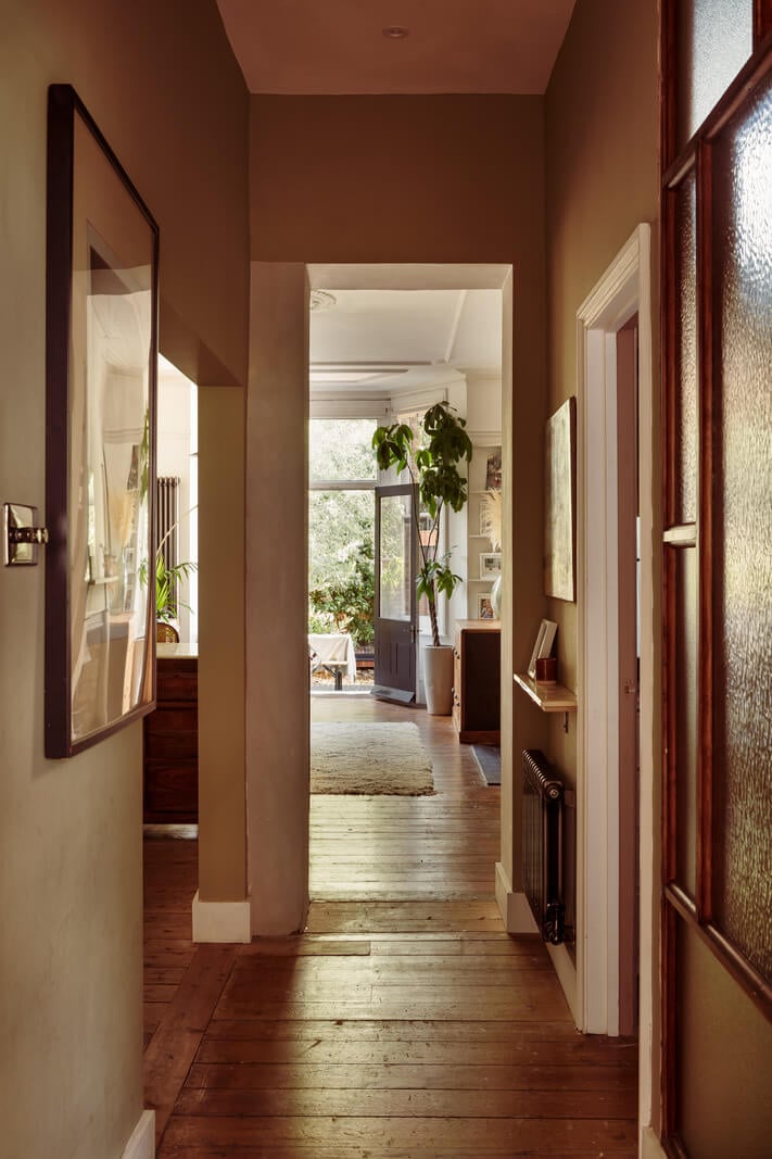 A Warm Ground Floor Apartment with Reclaimed Materials 16 hallway brown walls