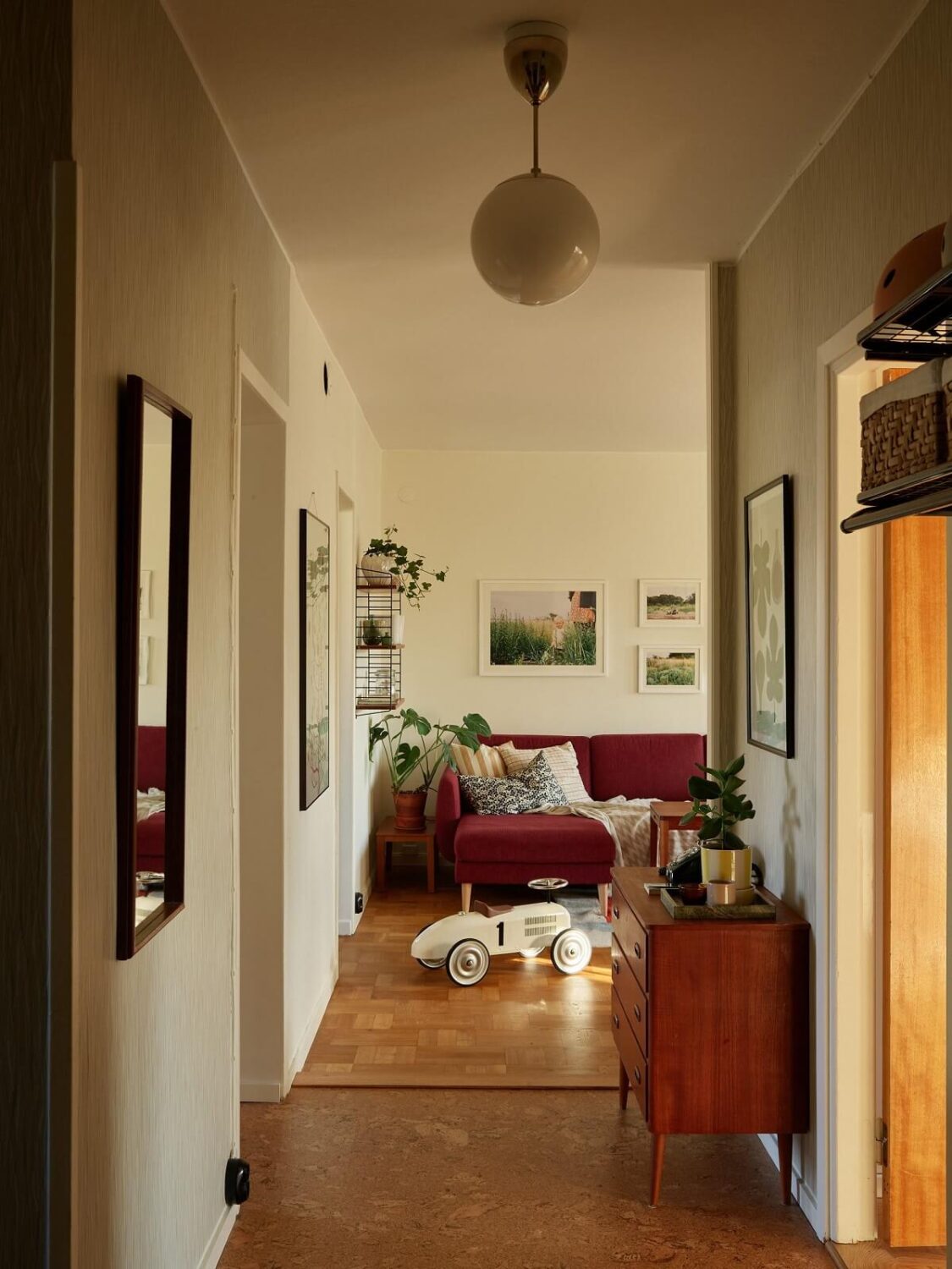 A Midcentury Swedish Apartment with Bold Colors 6 hallway view into living room