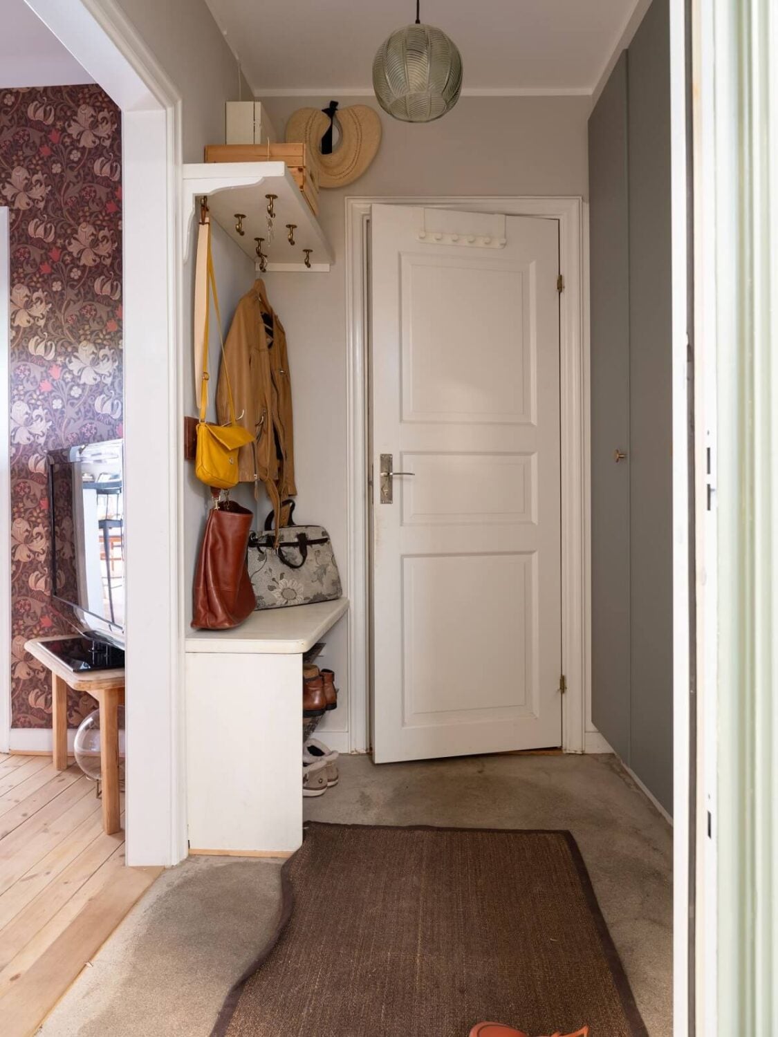 A Small Apartment with an Ochre Yellow Kitchen 20 hallway with floor to ceiling cabinets