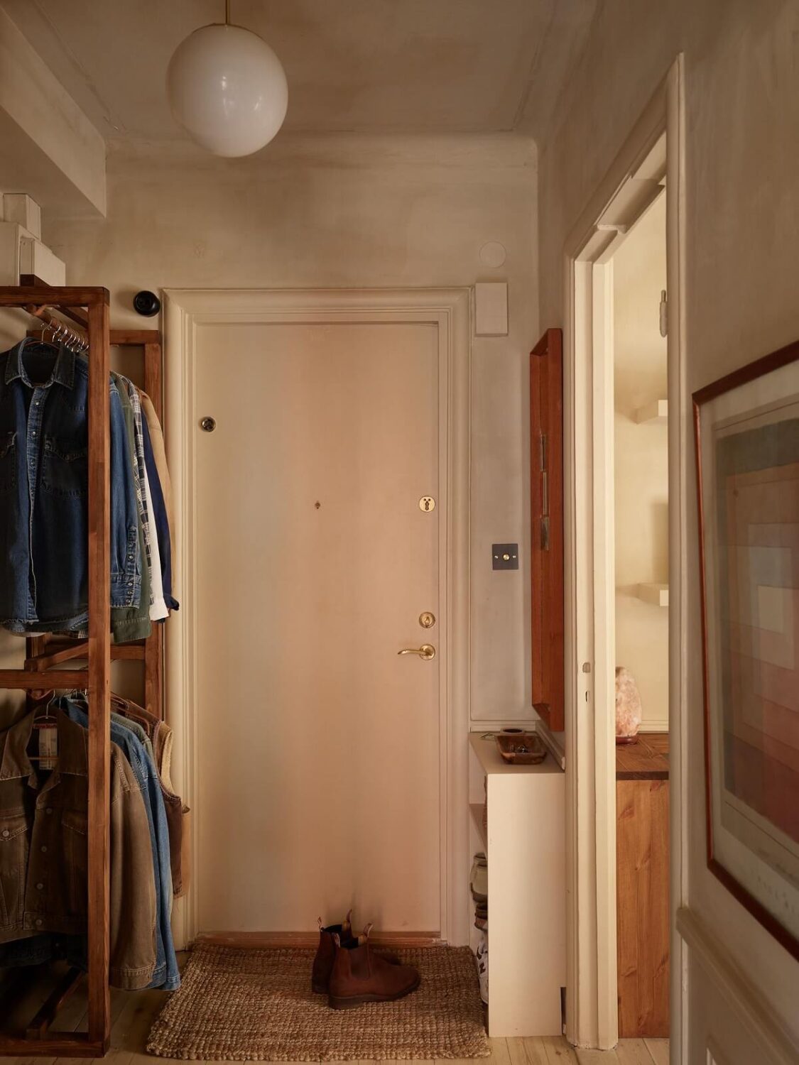 A Studio Apartment with Plaster Walls and a Walnut Kitchen 20 hallway with open wardrobe