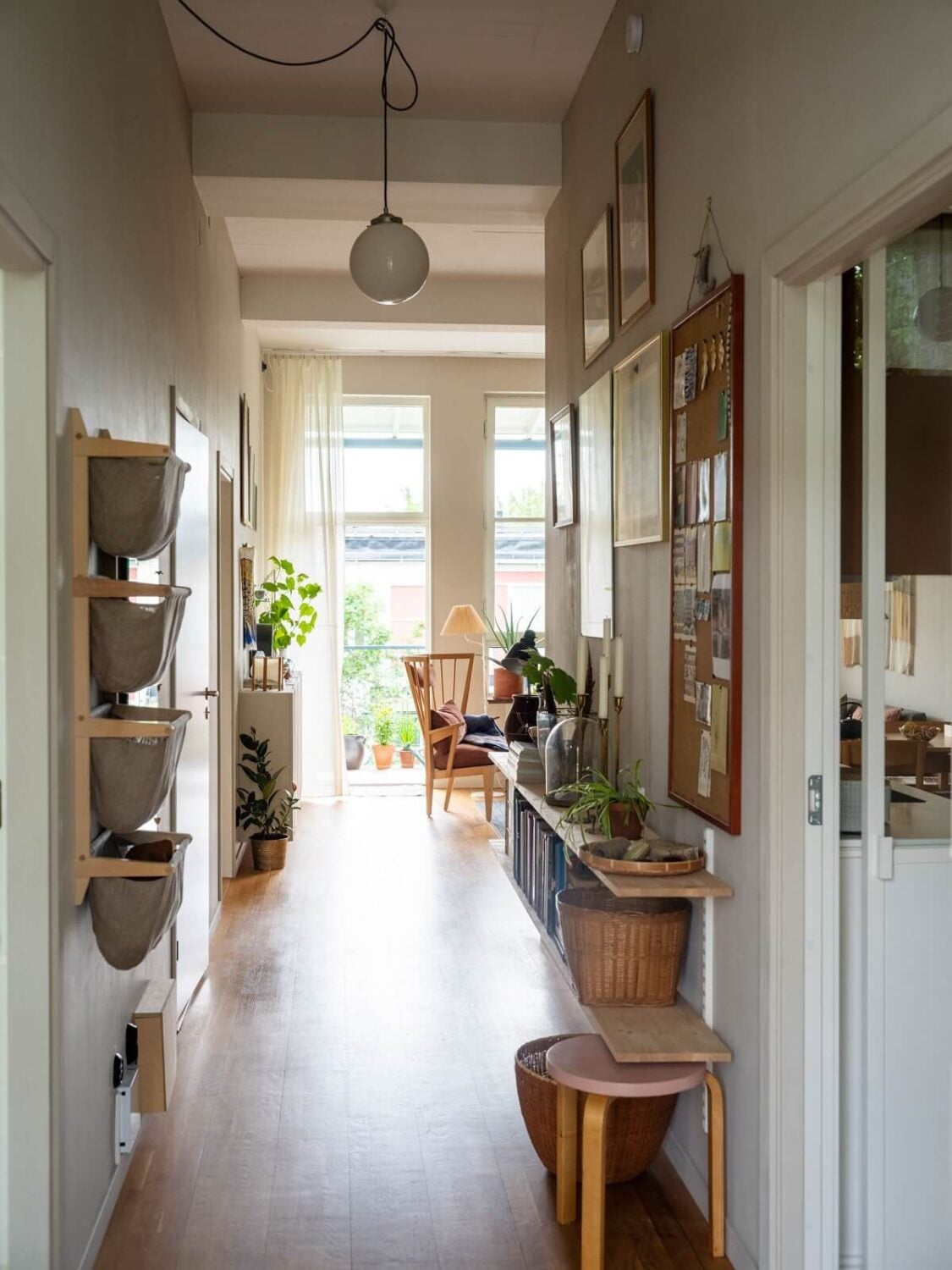 A Scandinavian Family Apartment with a Rusty Red Kitchen 25 hallway with shelves and baskets
