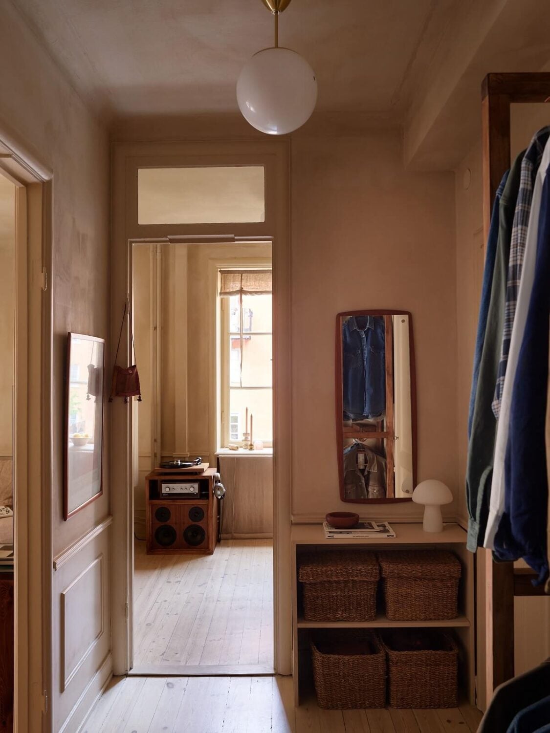 A Studio Apartment with Plaster Walls and a Walnut Kitchen 18 hallway with storage baskets