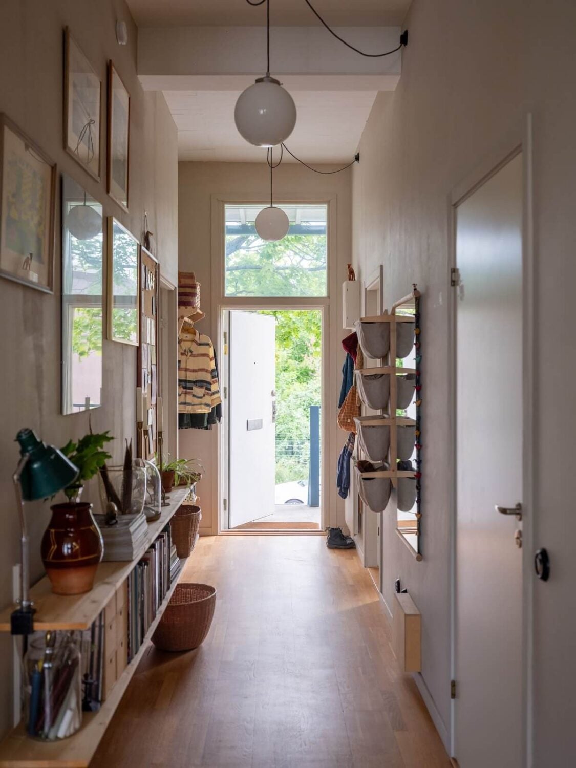 A Scandinavian Family Apartment with a Rusty Red Kitchen 26 hallway with storage baskets
