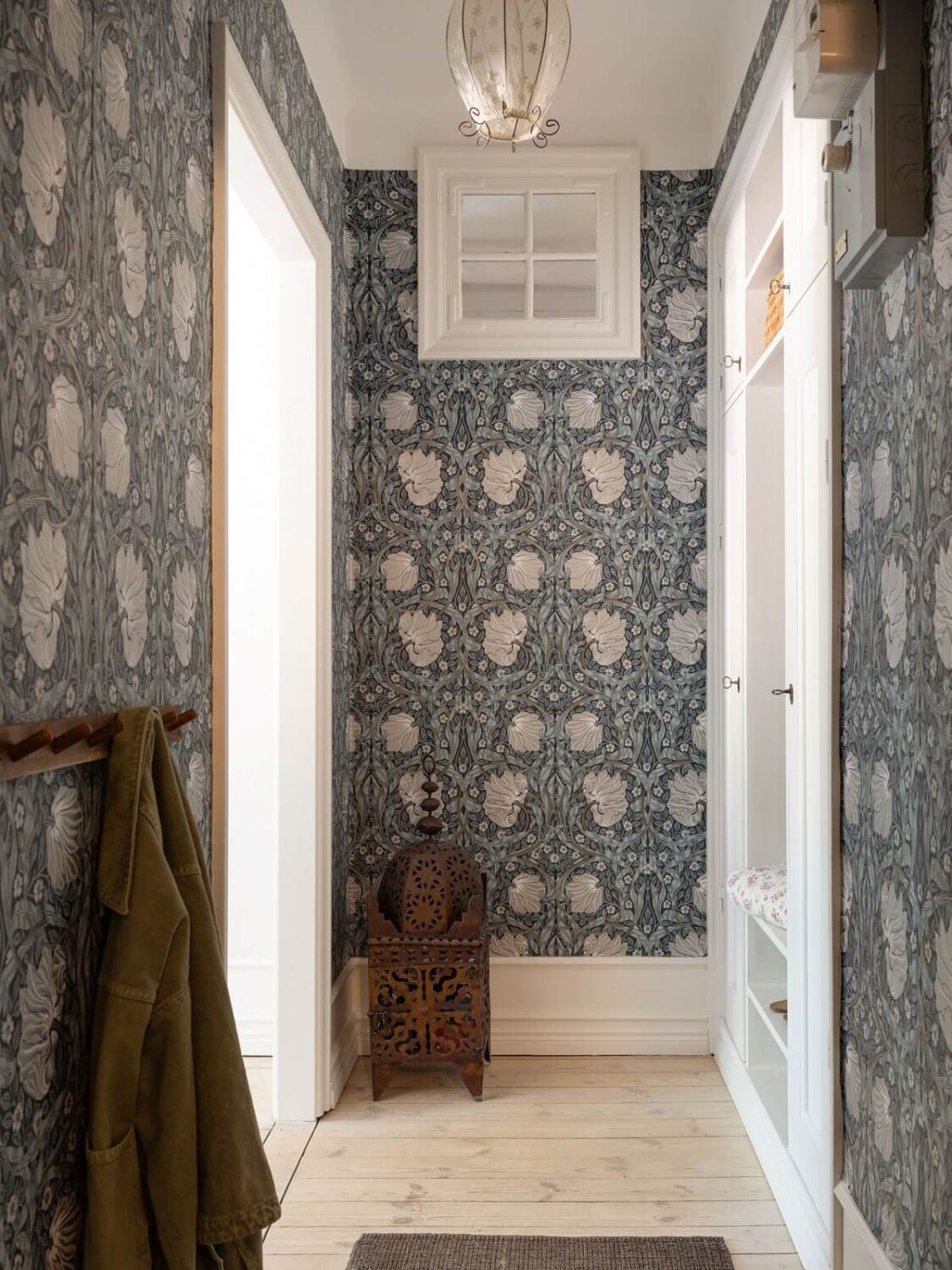 A Light and Well-Planned Apartment in Stockholm 17 hallway with william morris wallpaper