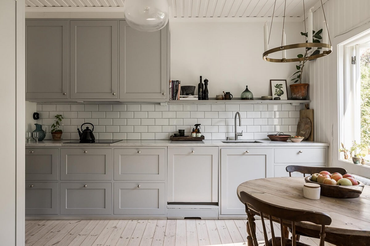 A Lovely Early 20th Century House with Wallpapers 9 kitchen light gray cupboards round wooden table