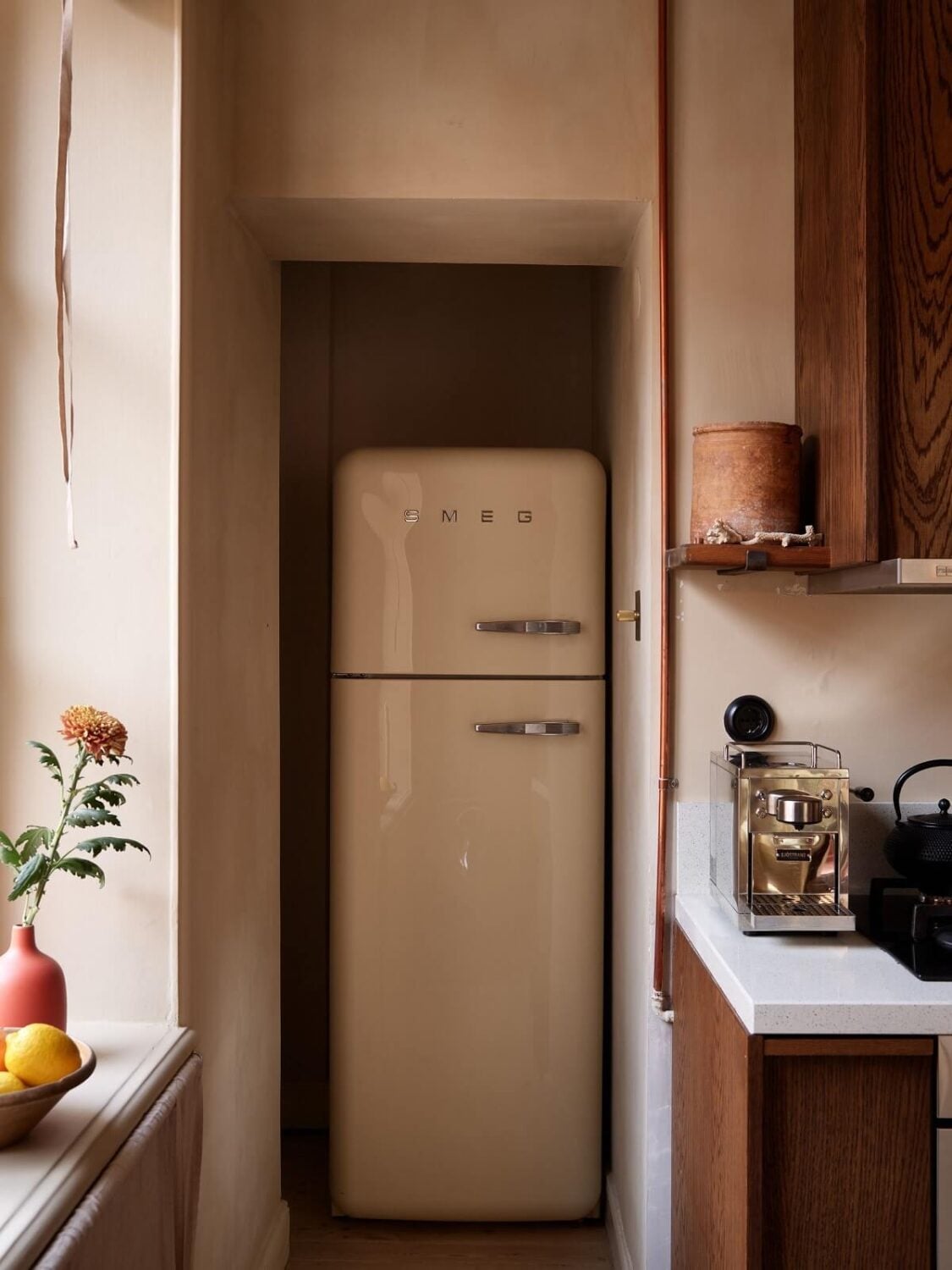 A Studio Apartment with Plaster Walls and a Walnut Kitchen 13 kitchen niche for fridge