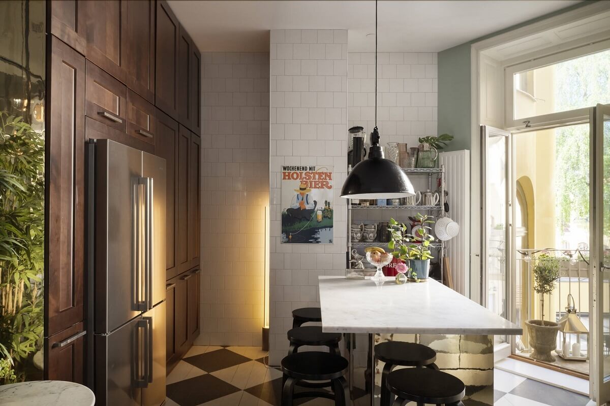 Bright, Spacious Rooms in a Classic Stockholm Apartment 10 kitchen with checkerboard floor and floor to ceiling cabinets