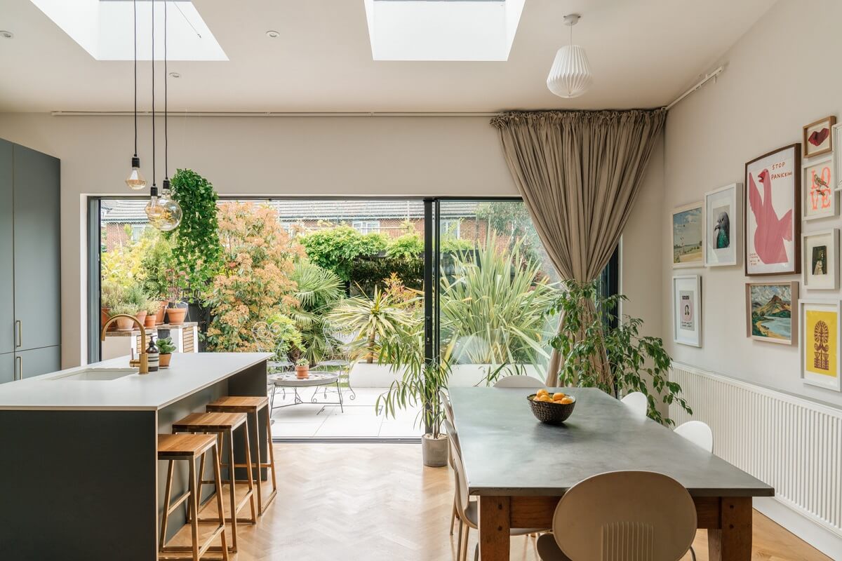 A Dark Blue Living Room in a Historic London Home 7 kitchen with dining table and skylights
