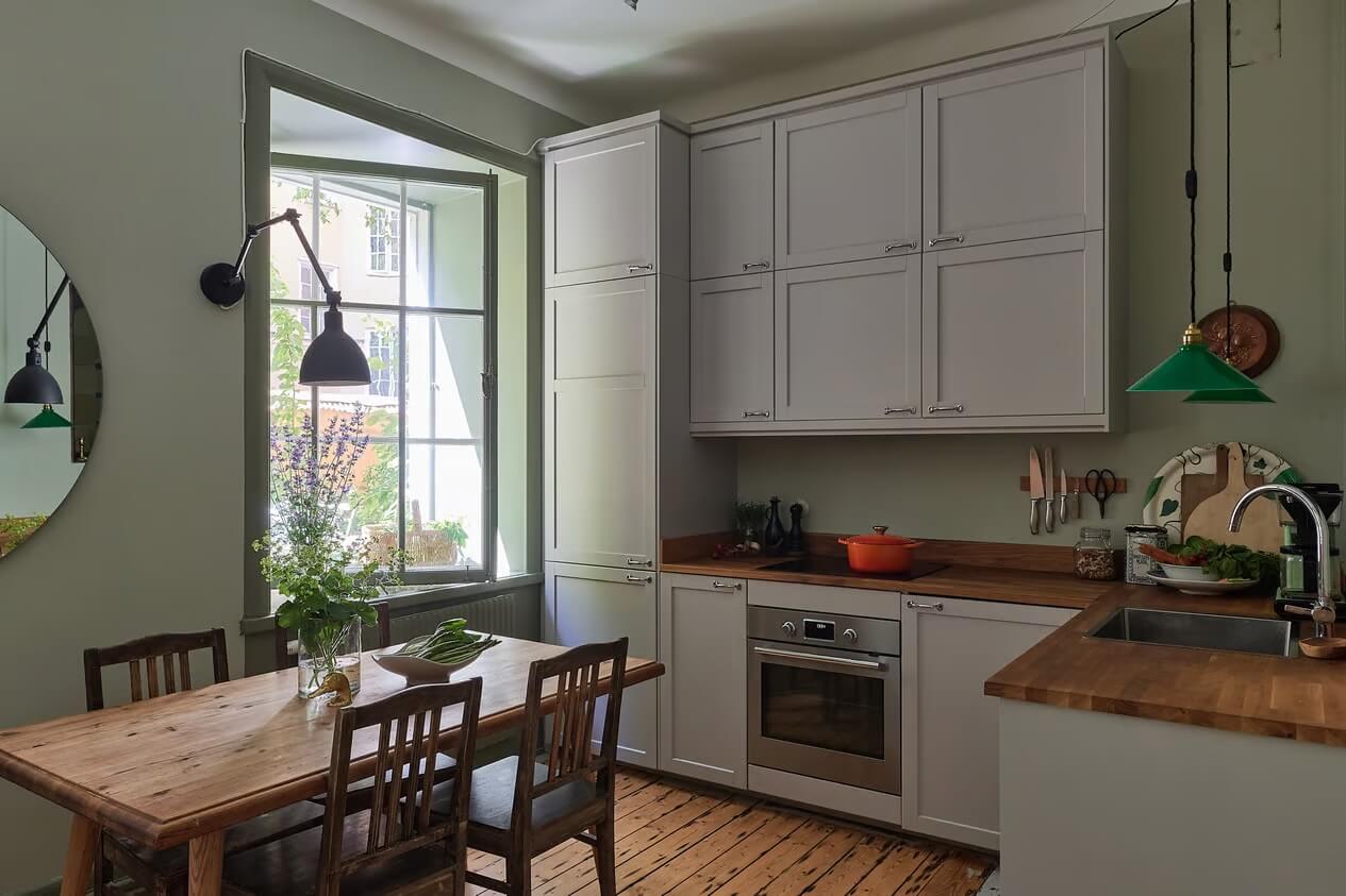 Soothing Colors and Smart Solutions in a Two Bedroom Apartment 2 kitchen with gray cabinets and green walls
