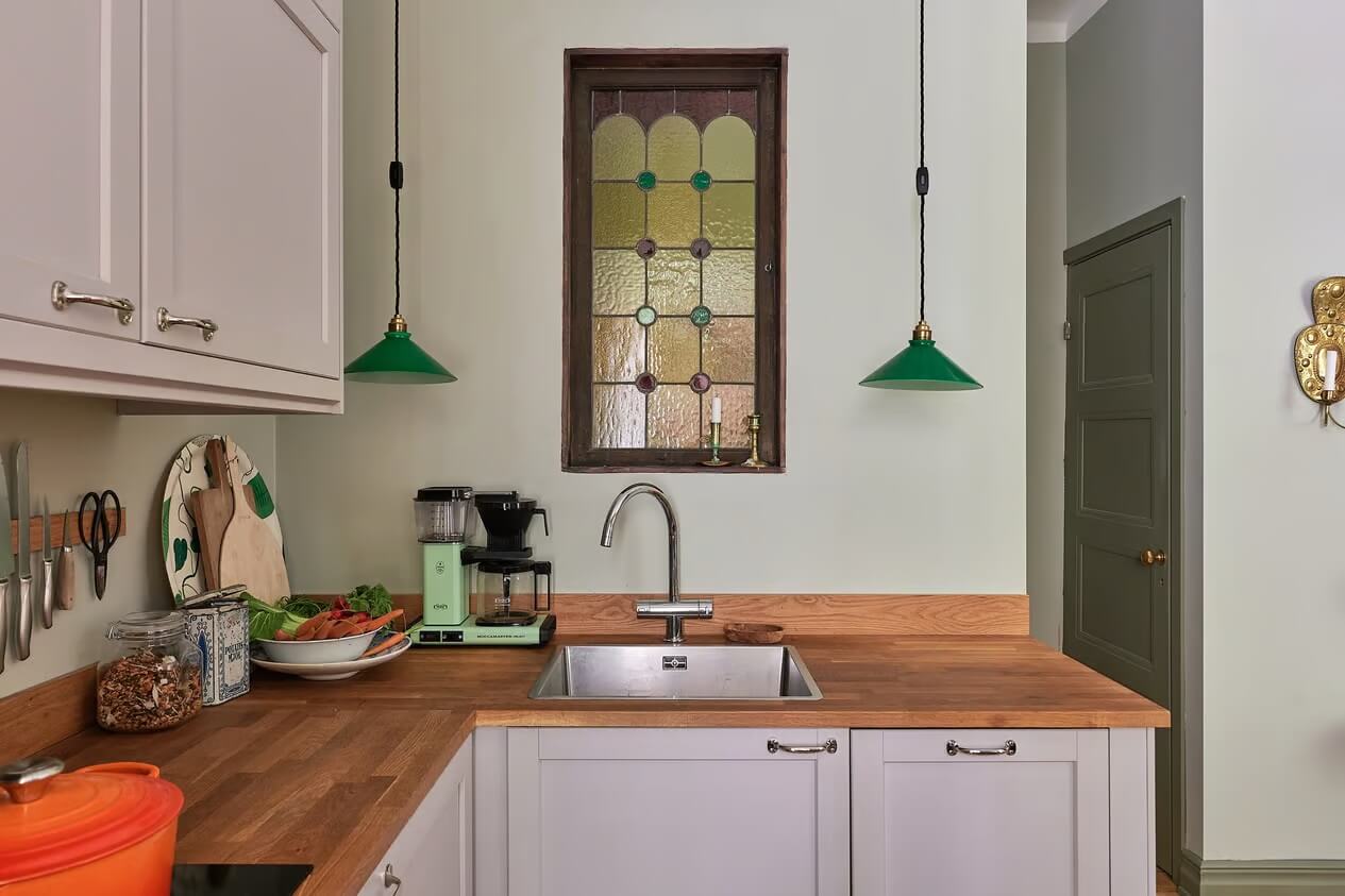 Soothing Colors and Smart Solutions in a Two Bedroom Apartment 5 kitchen with green pendants
