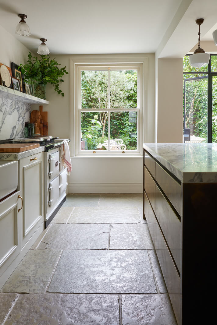 A Luxurious Two-Bedroom Maisonette in Primrose Hill 9 kitchen with island and stone floor