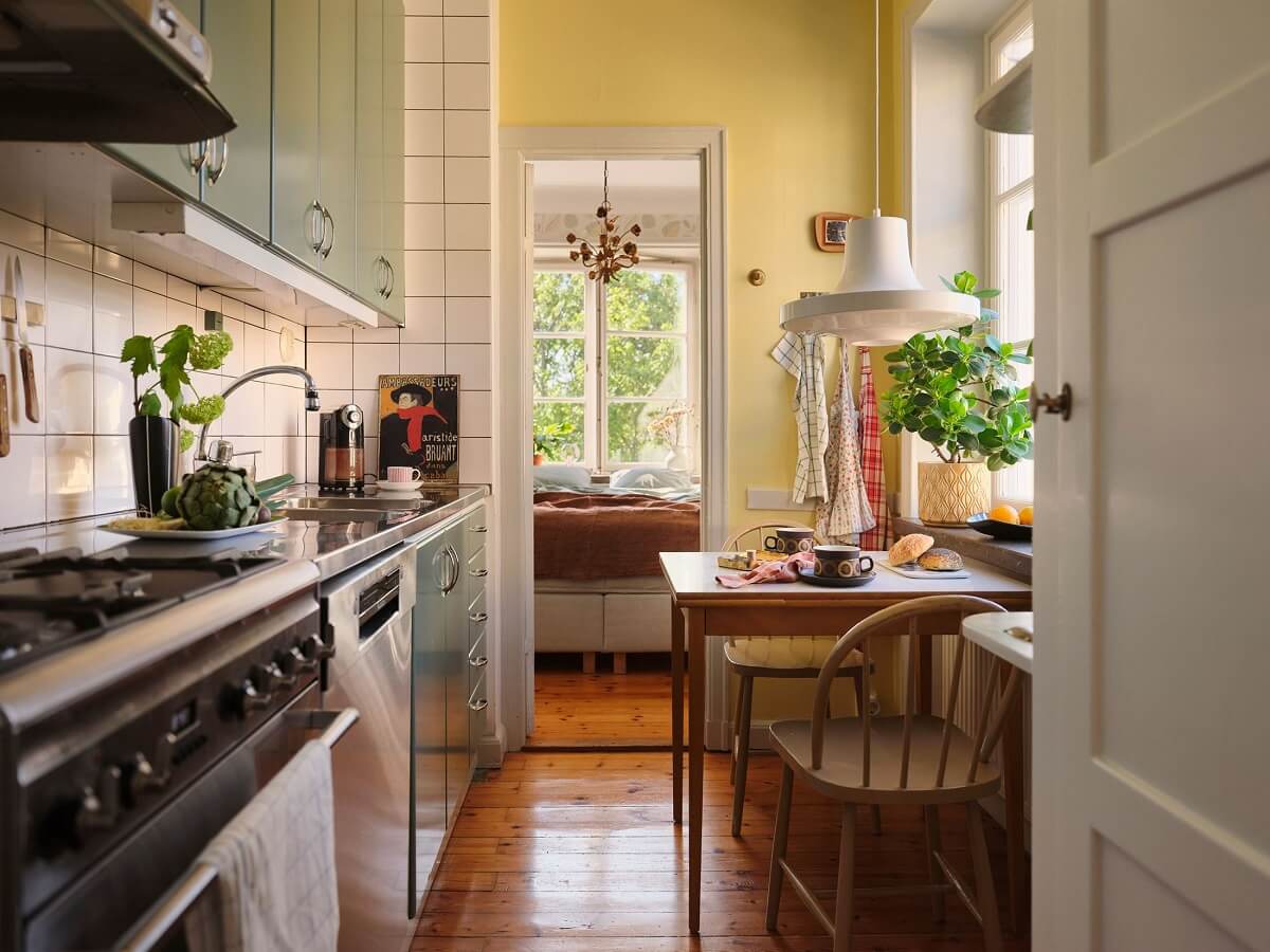 A Charming Small Two-Bedroom Apartment in Stockholm 12 kitchen with pastel yellow wall and small table