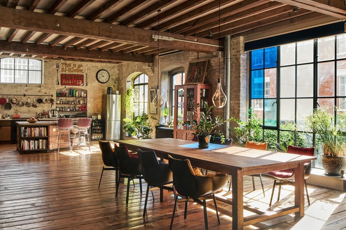 An Industrial and Colorful Warehouse Conversion in London 2 large dining table warehouse apartment london