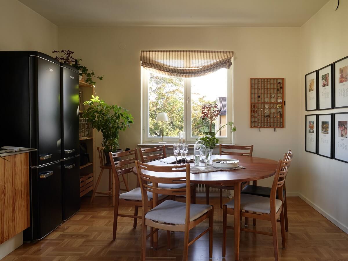 A Midcentury Swedish Apartment with Bold Colors 7 large kitchen with round dining table