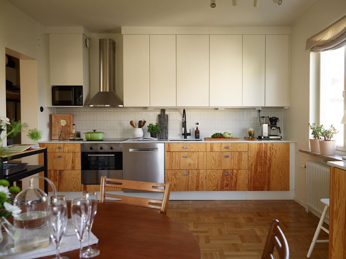 A Midcentury Swedish Apartment with Bold Colors 10 large kitchen wooden and white cabinets